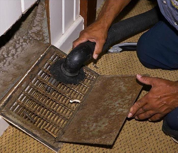 Person Cleaning HVAC Ducts